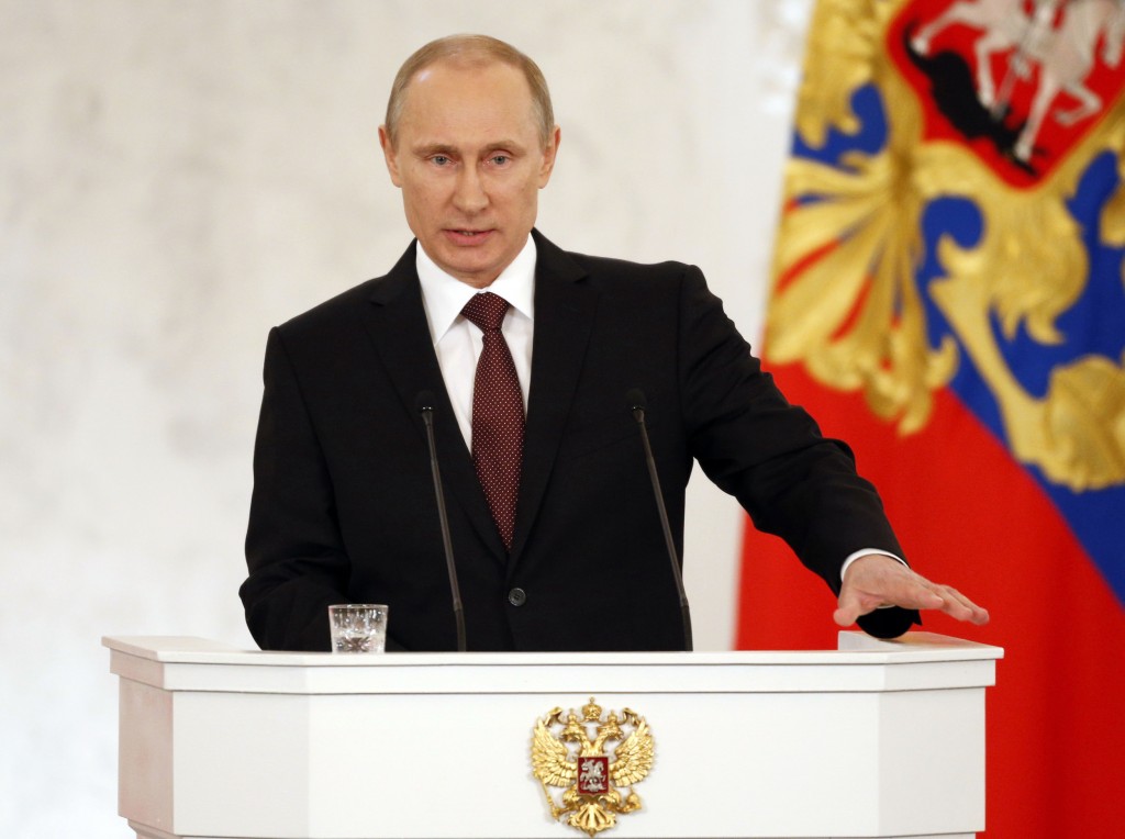 Russia's President Vladimir Putin addresses the Federation Council in Moscow's Kremlin on Tuesday, March 18, 2014. Putin defended Russia?s move to annex Crimea, saying that the rights of ethnic Russians have been abused by the Ukrainian government. Image Source: www.aol.com