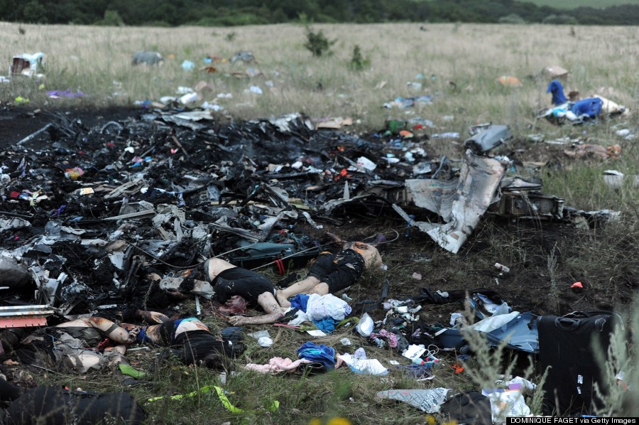 A picture taken on July 17, 2014 shows bodies amongst the wreckages of the malaysian airliner carrying 295 people from Amsterdam to Kuala Lumpur after it crashed, near the town of Shaktarsk, in rebel-held east Ukraine.  Image Source: huffpost.com